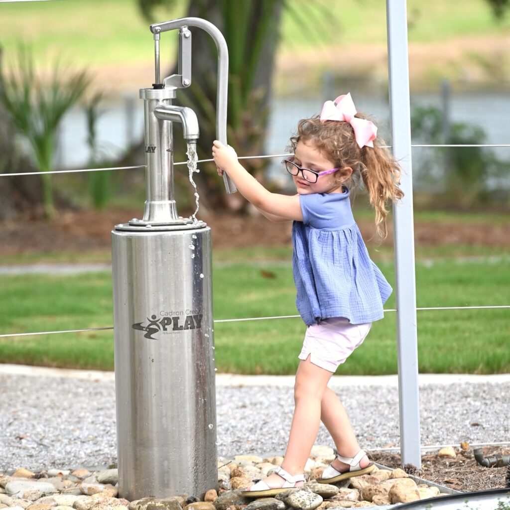 A child using the Pump-n-Play system at the Louisiana Children’s Museum outdoor exhibit