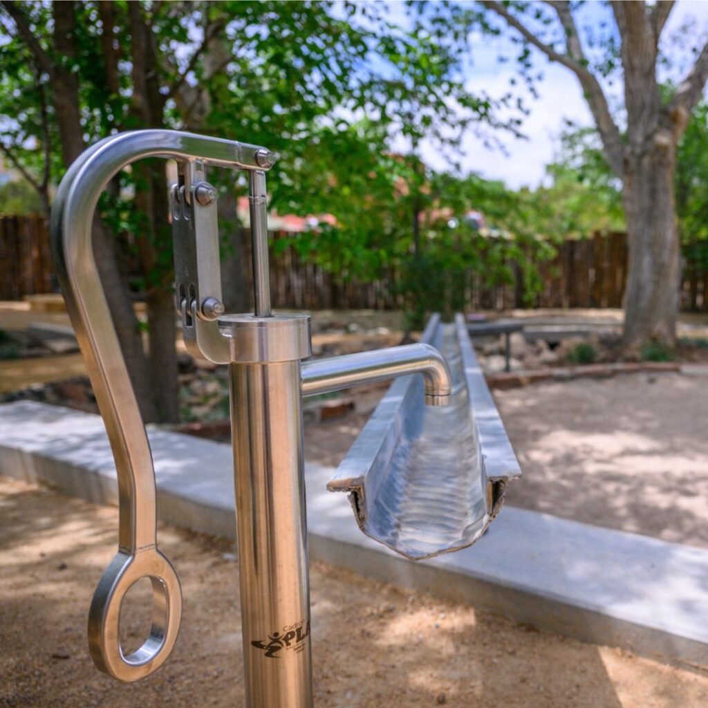 A Cadron Creek Play pump is featured in an outdoor space at the Santa Fe Children's Museum in New Mexico
